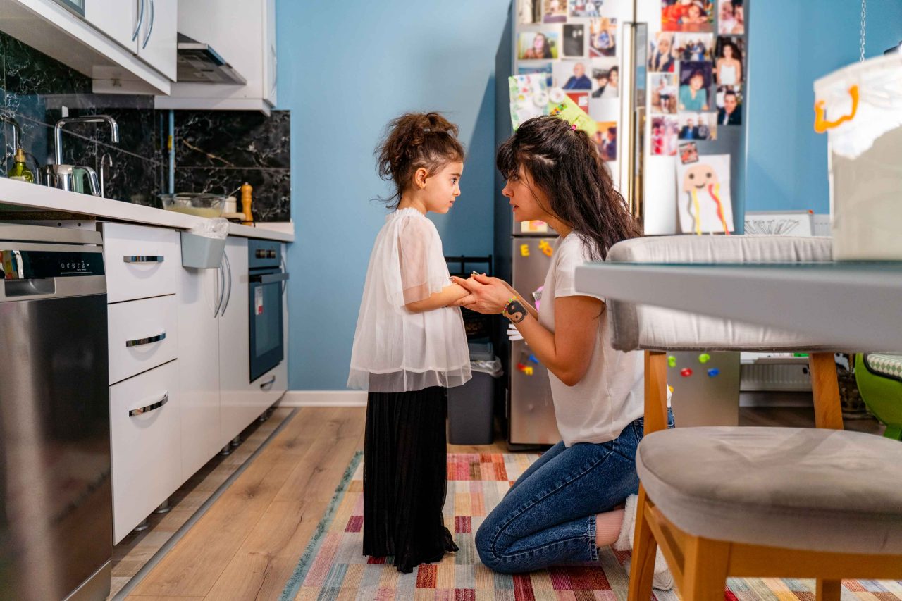 Mother and daughter talking in the kitchen