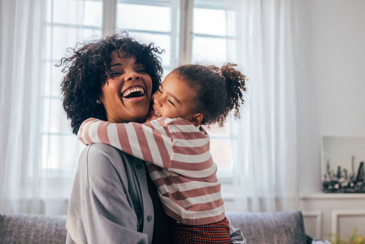mother and daughter smiling and hugging