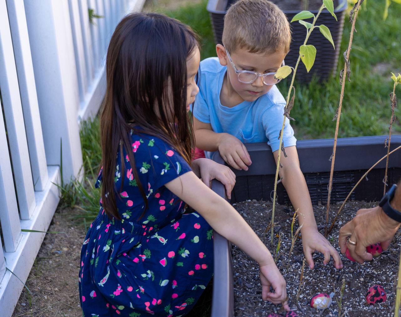 two children helping in garden