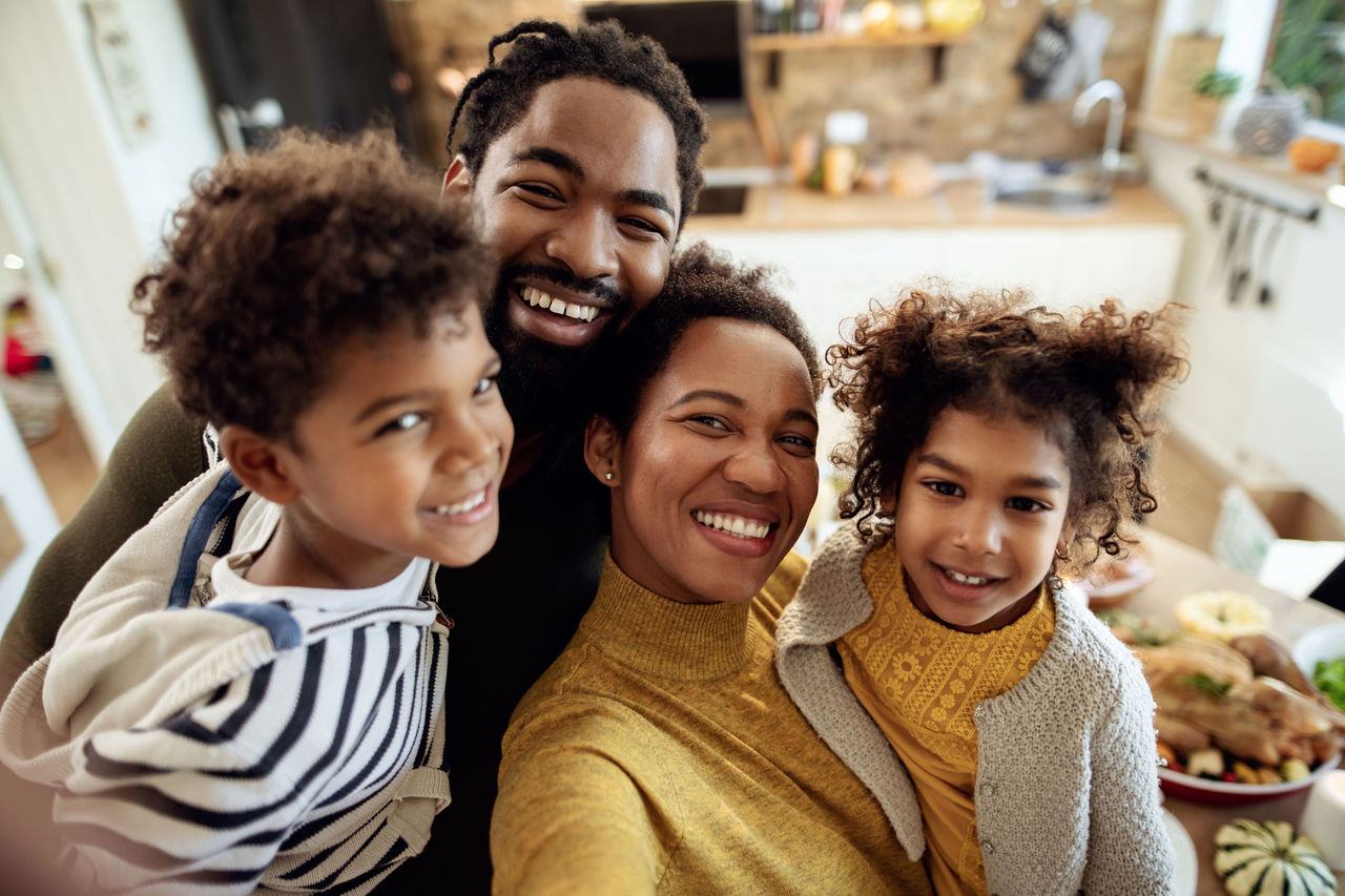 Happy family with two children in the kitchen